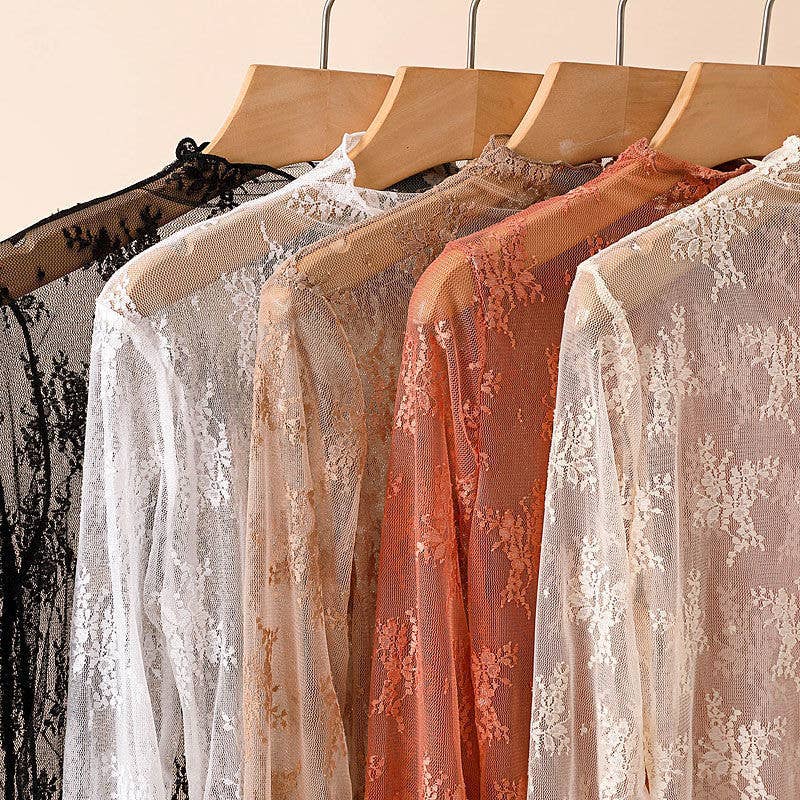 Lace garments on hangers against a neutral background