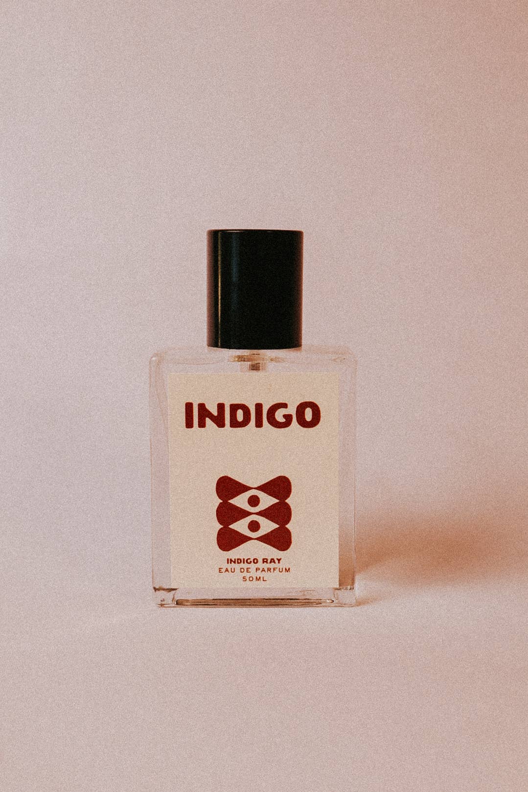 Indigo perfume spray by Indigo Ray featuring clean modern bottle design and warm neutral styling